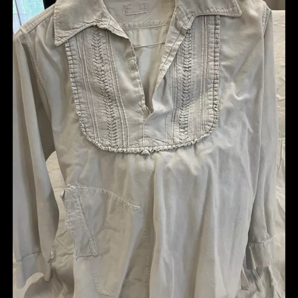 White long sleeve blouse with ruffled bib collar and relaxed fit